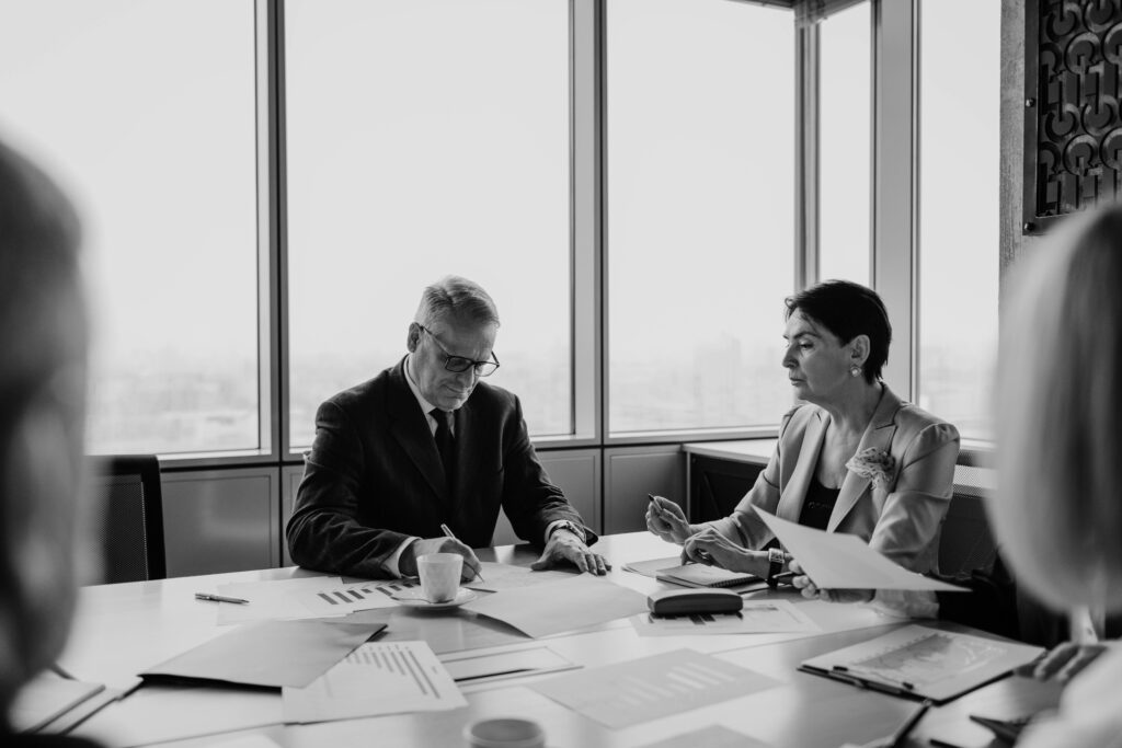 pexels-photo-7433854-7433854 Black and white image of a business meeting with diverse professionals collaborating.